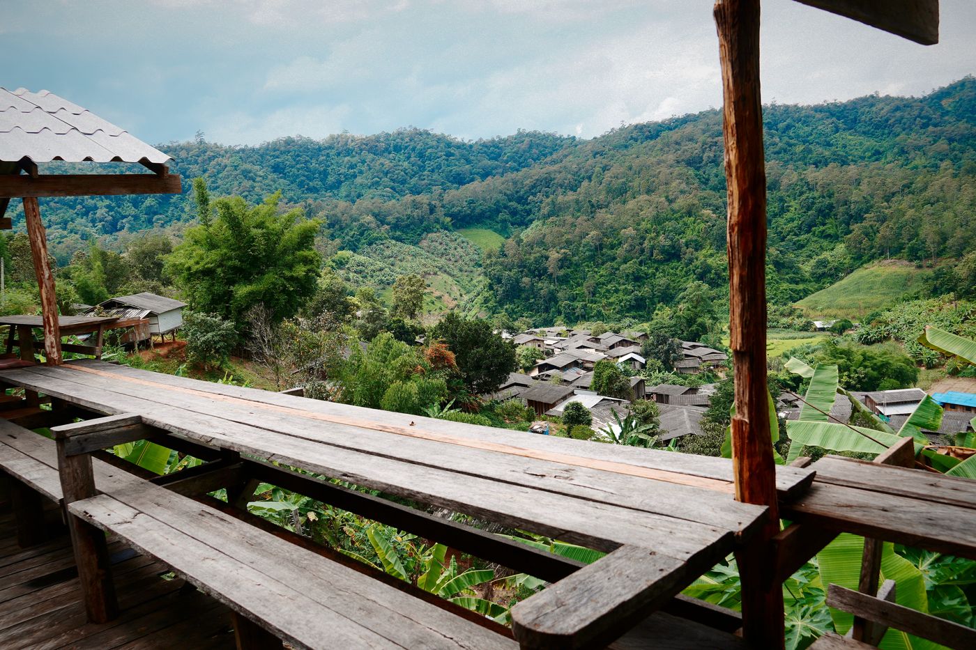 Wooden deck of the homestay looking over the green valley